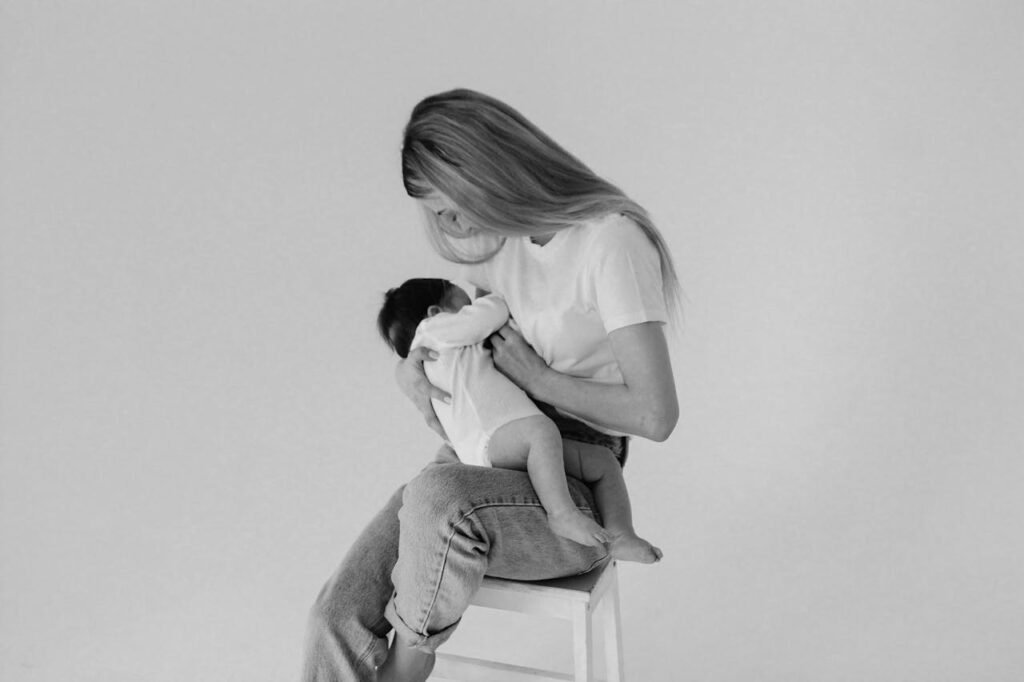 Grayscale Photo of a Mother Breastfeeding a Baby